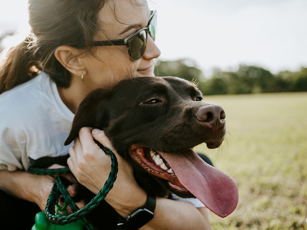 Girl and dog smiling